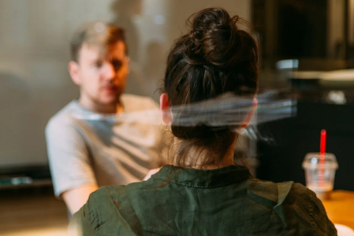 One person seated across from another in a quiet consultation