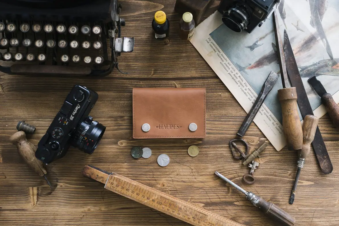 Assorted stationery items laid out on a brown wooden surface