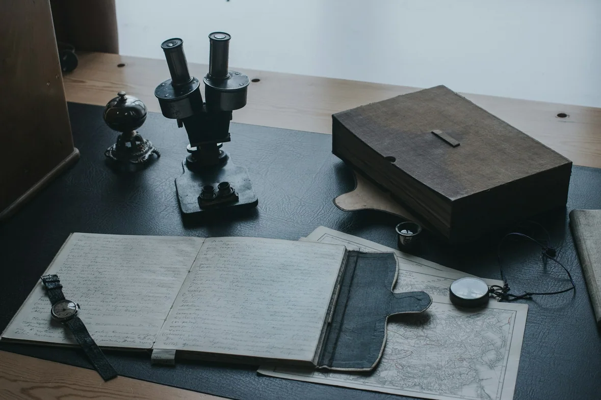 A metal tool resting on a dark wooden tabletop