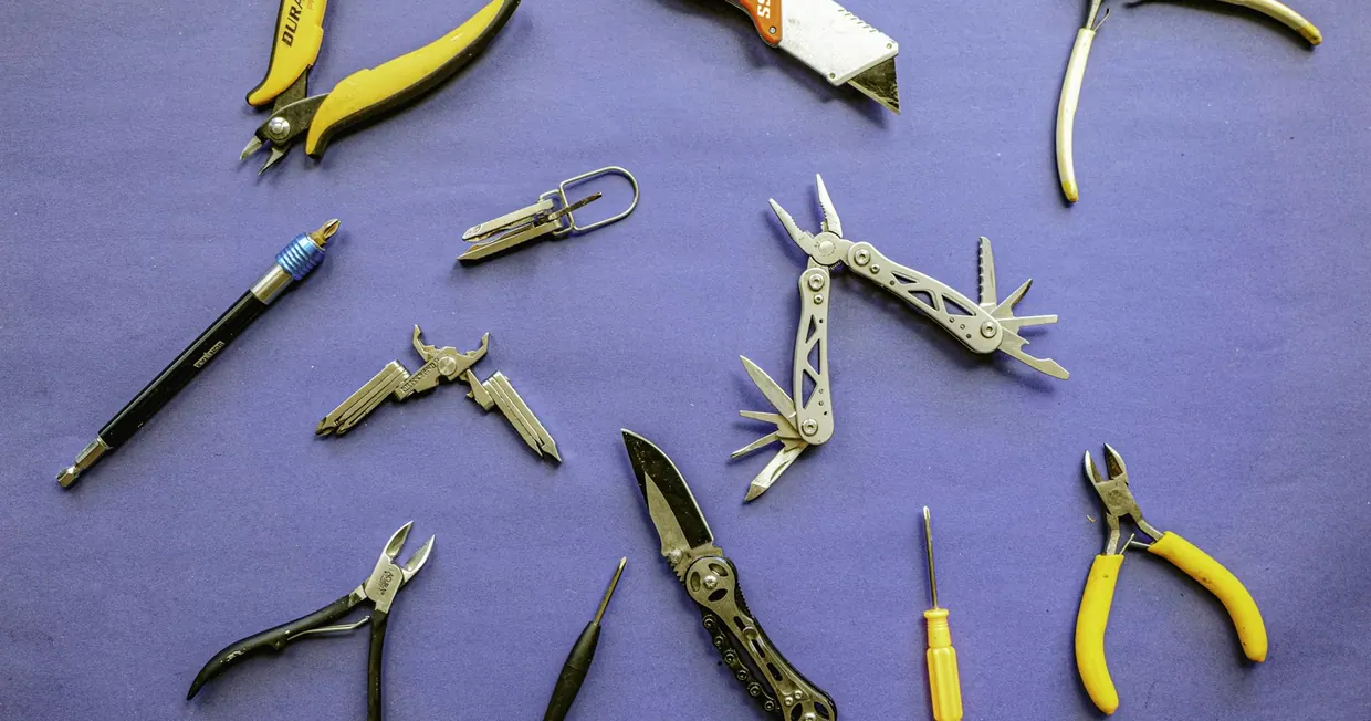An assortment of hand tools laid out neatly on a table