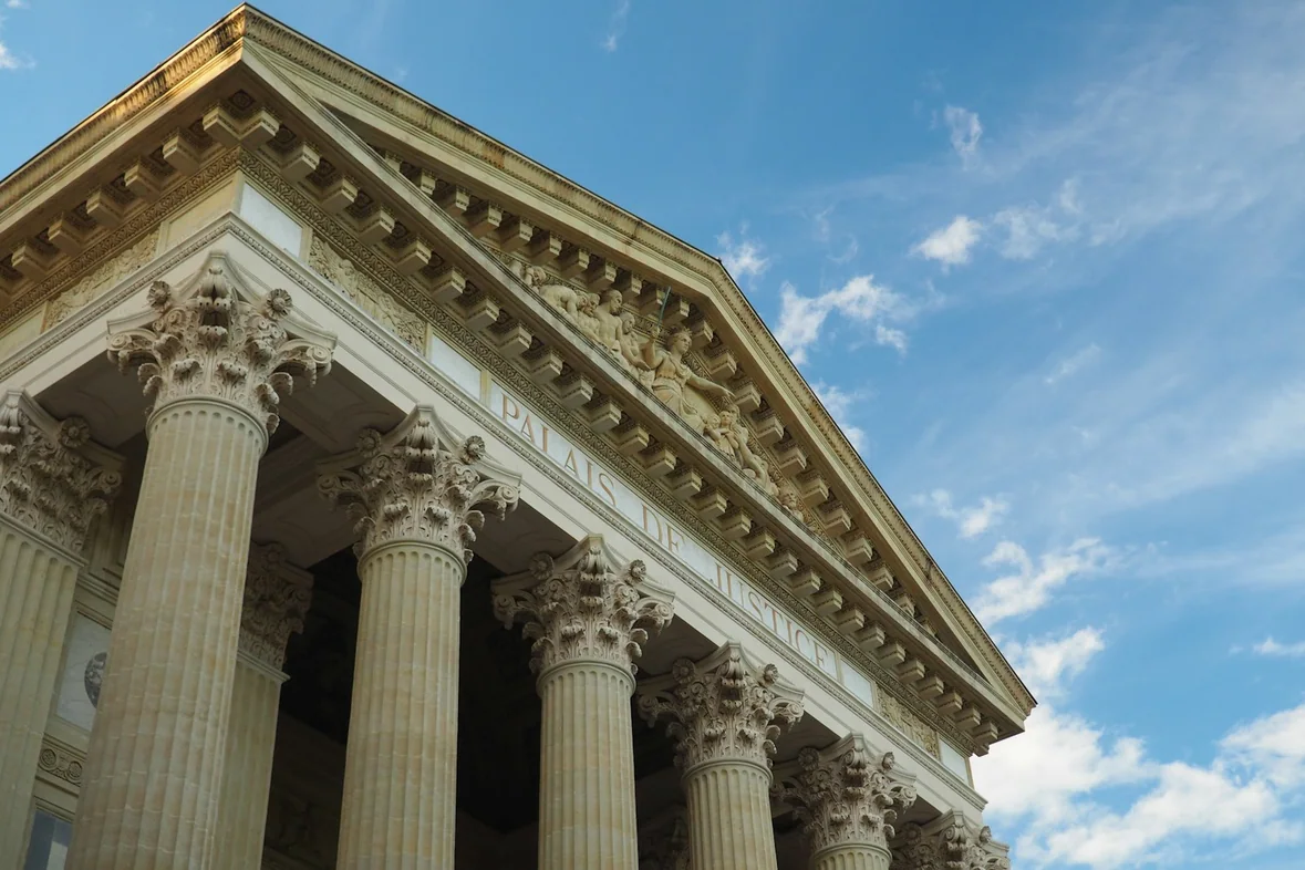 A tall public building with columns against an open sky