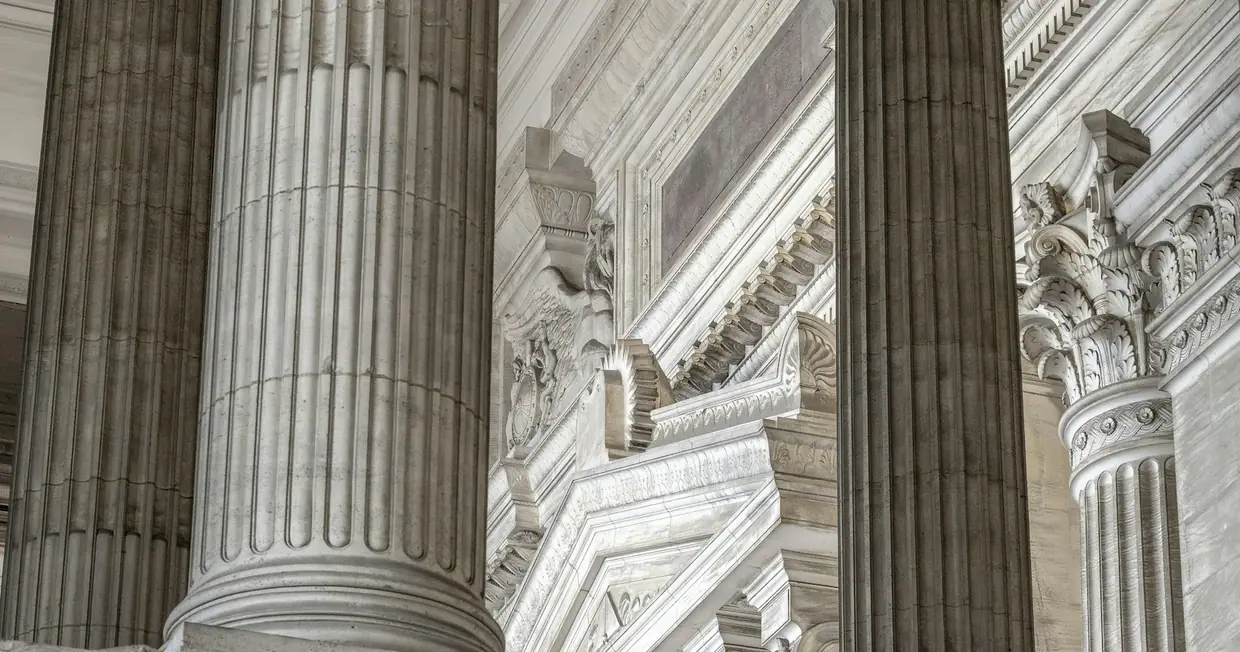 A neoclassical courthouse building with tall columns and a clock
