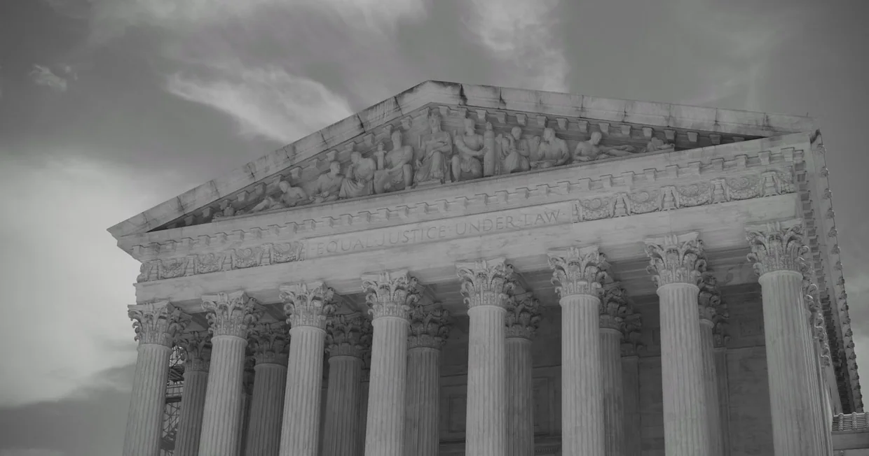 A grand neoclassical civic building with columns against the sky