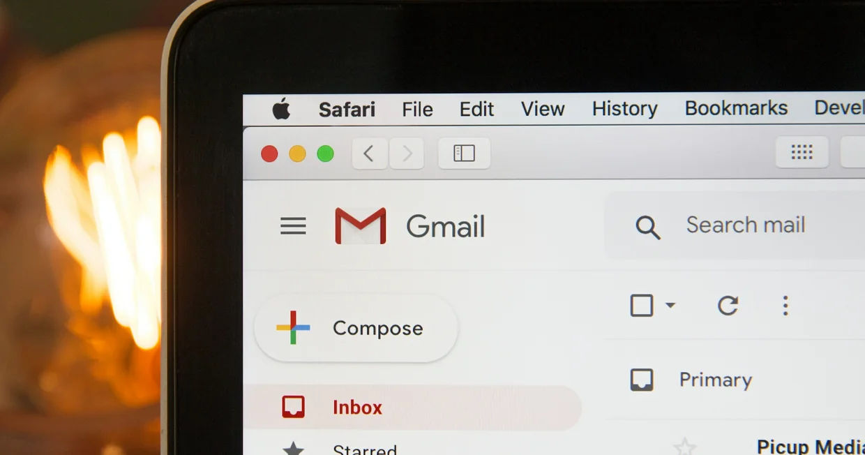 A laptop screen showing an open email inbox with a list of unread messages