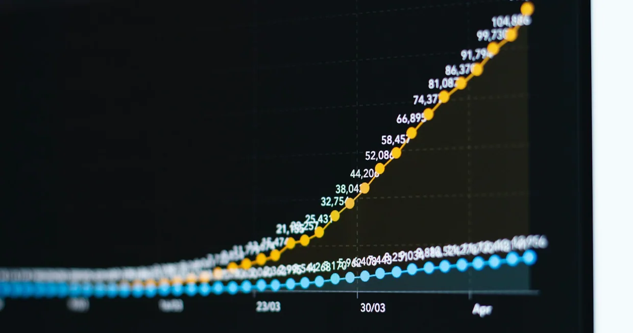 A line chart on screen showing one series climbing steadily while another stays flat