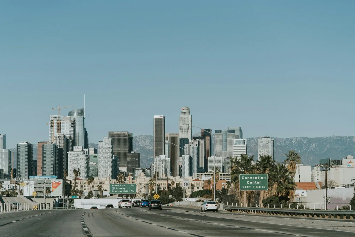 Traffic moving along a road with downtown Los Angeles buildings behind