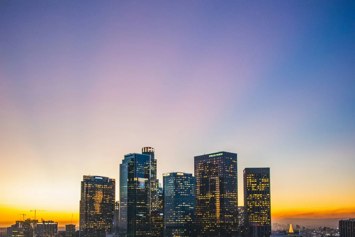 Los Angeles buildings photographed at sunset with warm light across the skyline