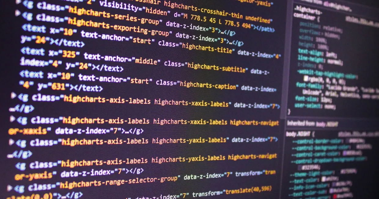 A desktop monitor displaying lines of code against a dark editor background