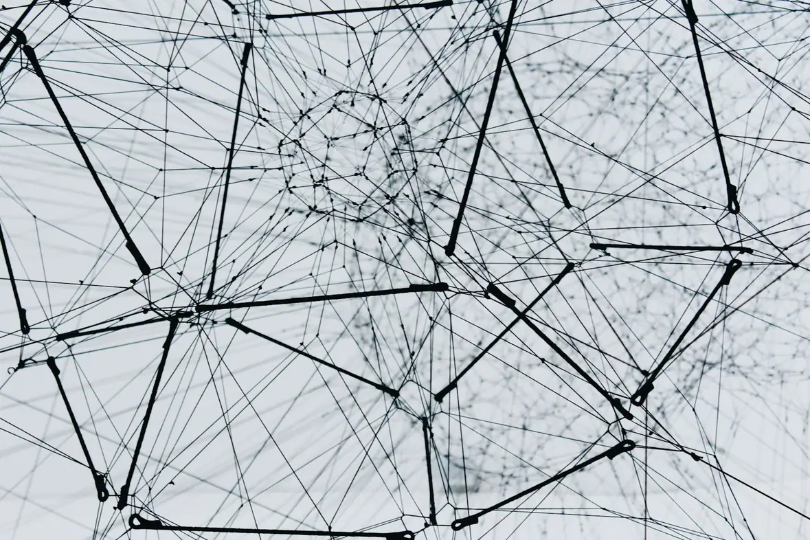 A metal lattice structure photographed from below against the sky