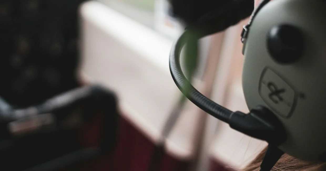 A close view of a person wearing a headset while taking a call