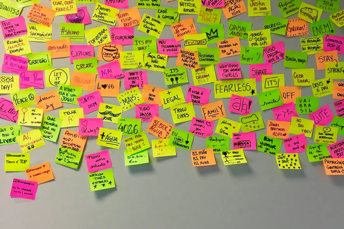 Assorted coloured sticky notes arranged in rows