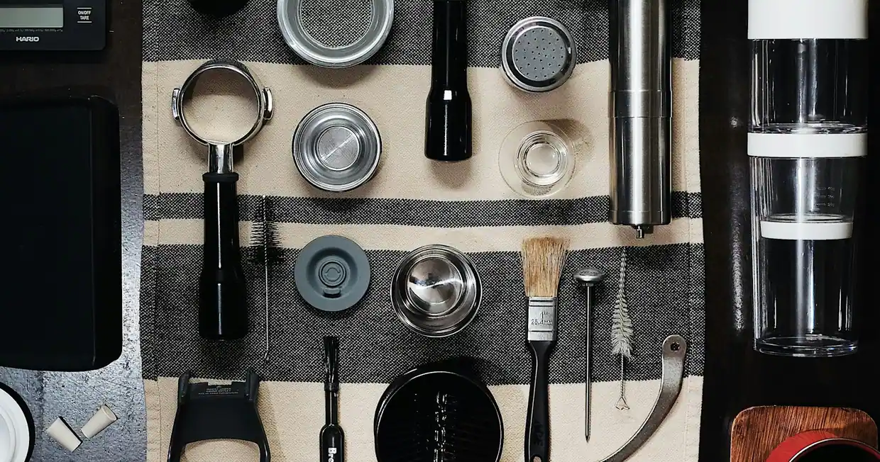 Kitchen and workshop tools arranged in a flat lay from above
