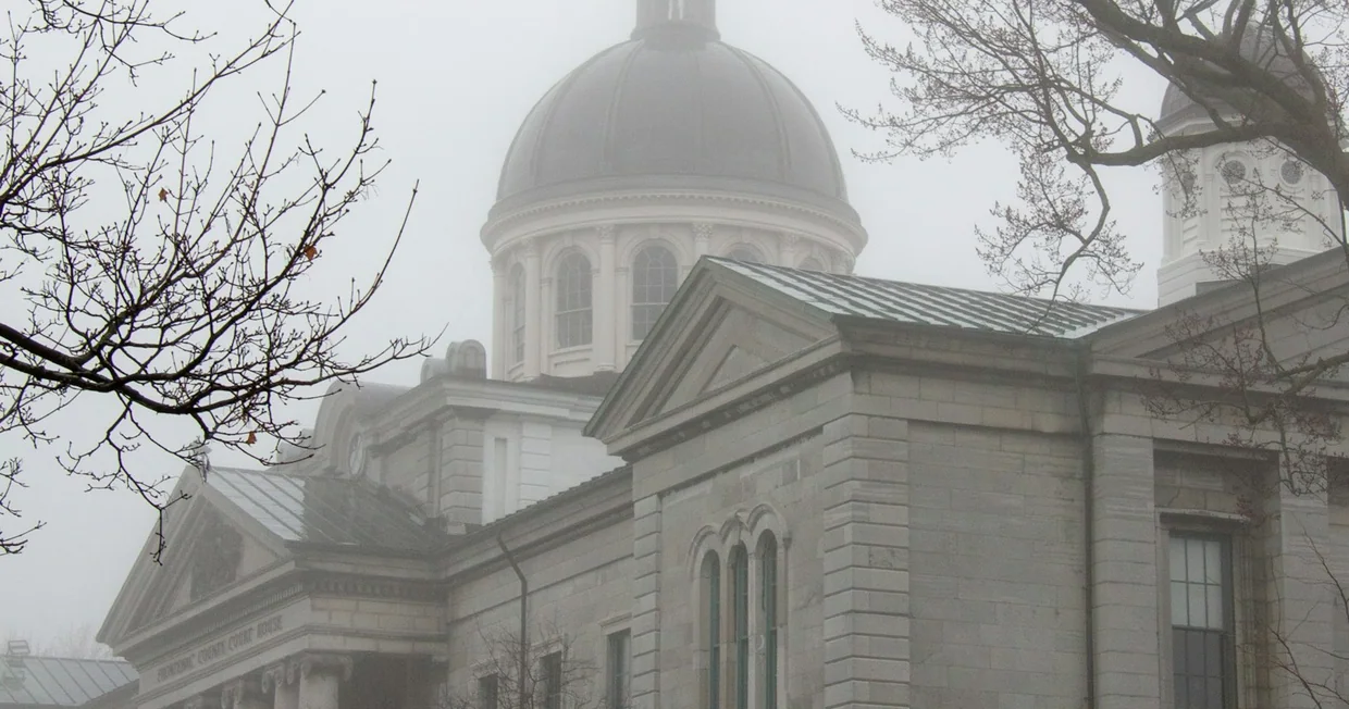 A historic domed building shrouded in fog