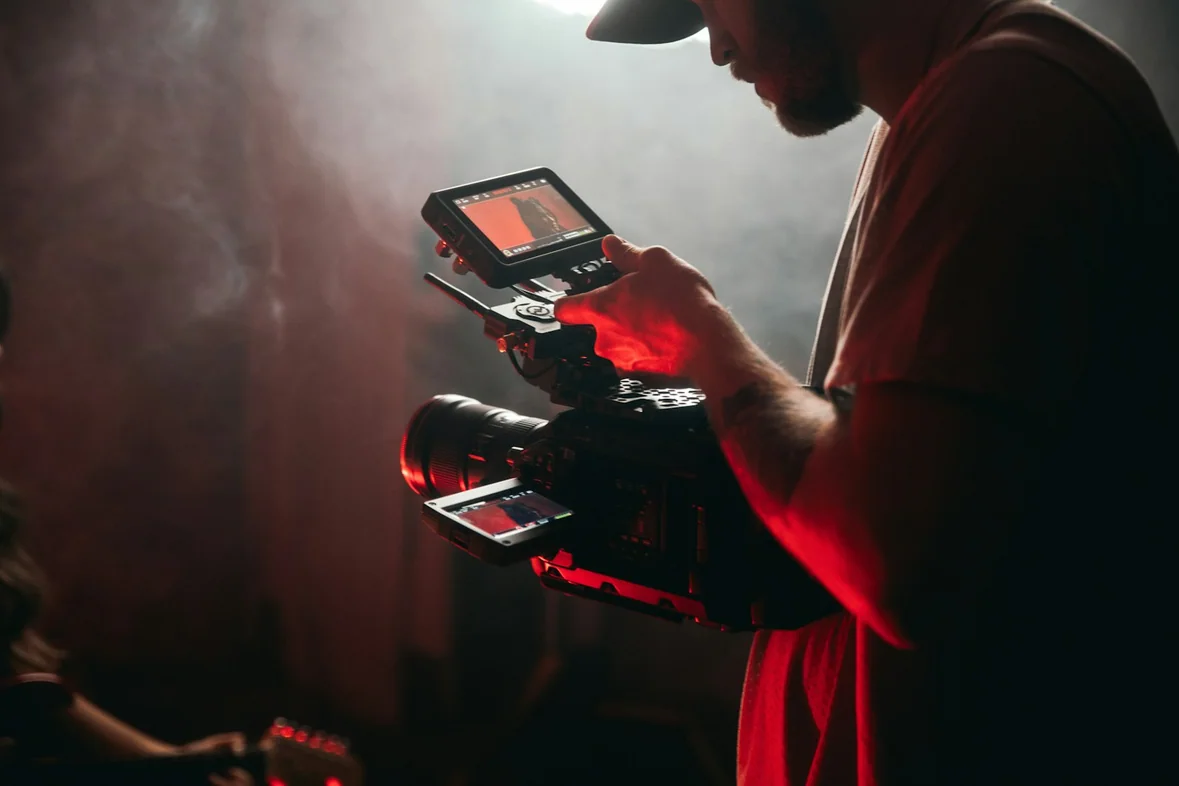 Someone holding a video camera in a bright room