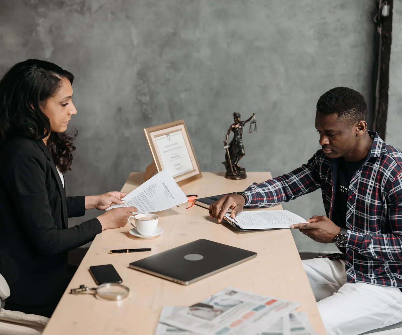 Two people going through case documents across a desk
