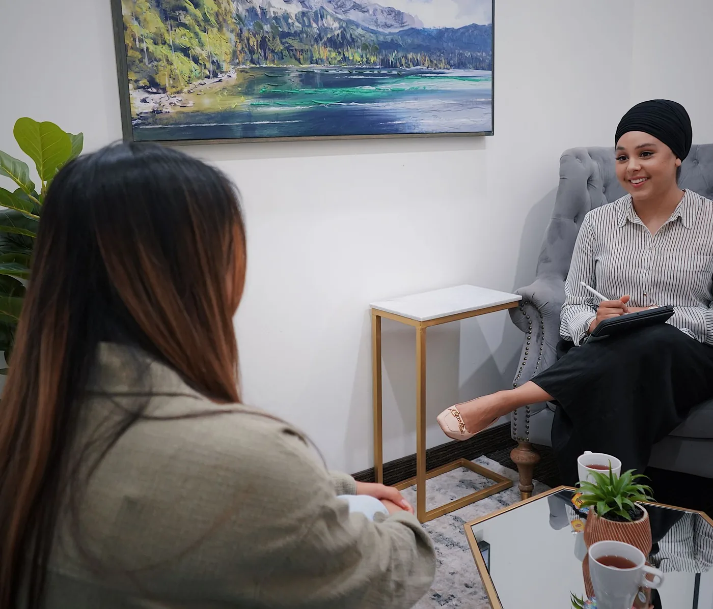 A client and an adviser in conversation in a calm, light-filled room